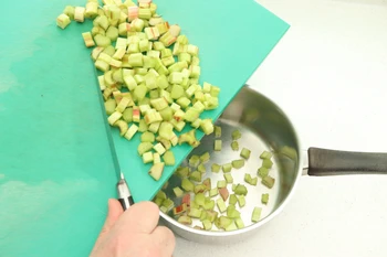 Pushing food from the board into the pan