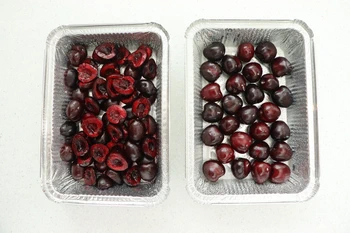 molds filled with cherries with and without pits