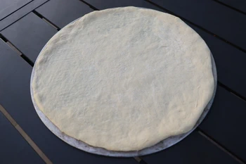 pizza dough disc on aluminum rack
