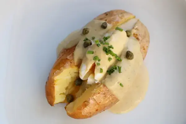 Baked potatoes with poached egg and tuna sauce