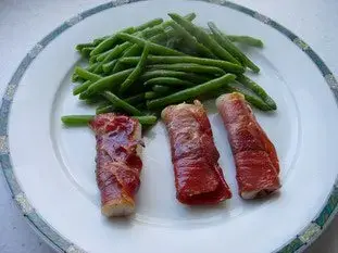 Rolls of fish in smoked ham