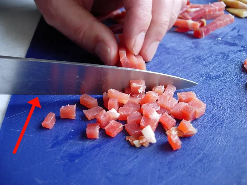 You should not push with the sharp edge of a knife