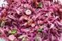 Salad of red cabbage with sliced radishes and toasted almonds.