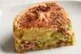 Deep quiche with a mixture of vegetables and bacon, quiche filling and 2 cheeses.