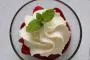 Strawberries in reduced red wine with thyme and lemon, and whipped cream.