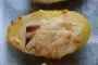 Cooked potatoes topped with bechamel sauce, ham and cheese, browned in the oven.