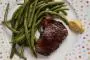 Beef tenderloin marinated in red wine with rosemary, then fried and served with green beans.