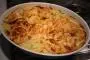 Classic potato gratin with diced ham fried with mustard.