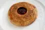 Shortcrust pastry pie filled with plums sprinkled with sugar.