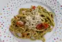 Spaghetti and cherry tomatoes with herbs, bound with pesto and cooking water.