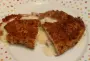 Chicken cutlet topped with ham, cheese and béchamel sauce, before being breaded.