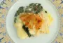 A layer of mashed potatoes on top of a layer of hard-boiled eggs, and a layer of spinach and bacon, tied together with a béchamel sauce.