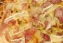 A plate of chips, topped with charcuterie and cheeses before a quick run under the grill.