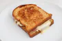 Toasted white bread, béchamel sauce with hard-boiled eggs, ham, and thin slices of cheddar.