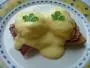 Soft-boiled egg on toast with grilled ham and Hollandaise sauce.