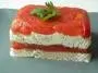 Layers of marinated tomatoes and cream cheese with herbs and walnuts.