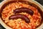 Dried beans boiled then cooked slowly with chopped tomatoes and sausages (preferably smoked).