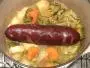 Smoked sausage with vegetables, casseroled in dry white wine.