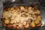 Two layers of sautéed potatoes around a layer of cooked minced beef, topped with grated cheese.